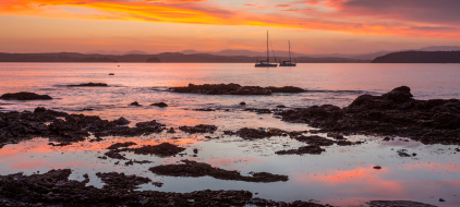 sunset low tide with yahts on the water