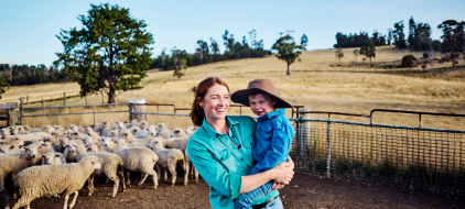 female farmer with toddler on hip